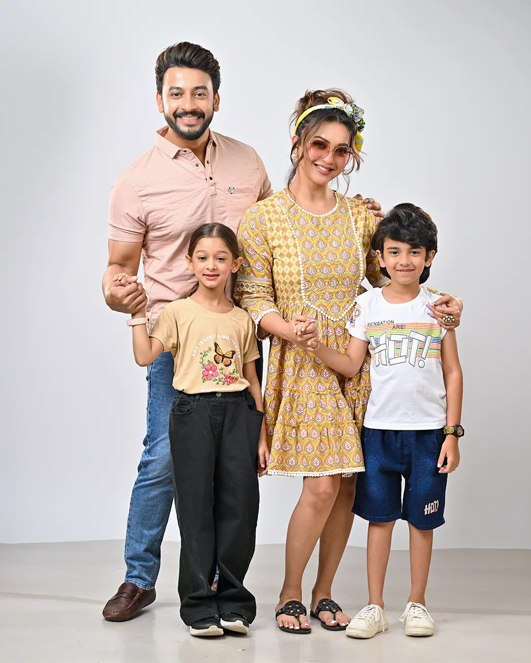 A family of four — two parents and two children — in A1 Bazaar clothing